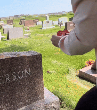 A phone scanning a Memorygram Medallion. The Virtual Memorial opens instantly, no app required.