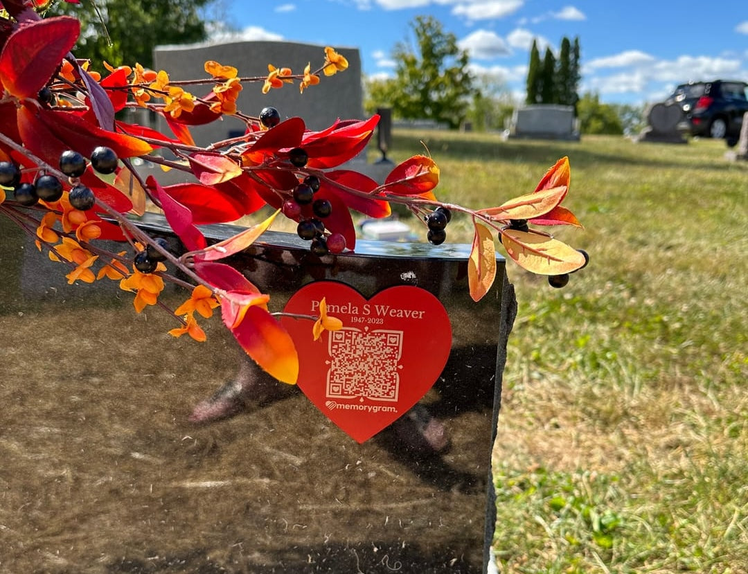 A Memorygram Medallion installed at a memorial. Photos, videos, and the loved one's voice live behind the engraved QR.